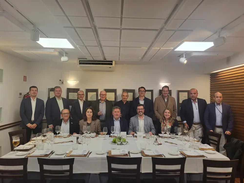 Doce empresarios y su invitado posan junto a la mesa de un Almuerzo CEO